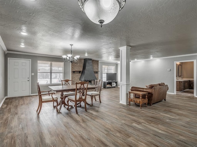 dining area with hardwood / wood-style flooring, ornate columns, and ornamental molding