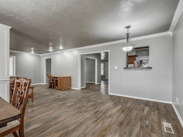 unfurnished dining area featuring a textured ceiling, dark hardwood / wood-style flooring, and crown molding