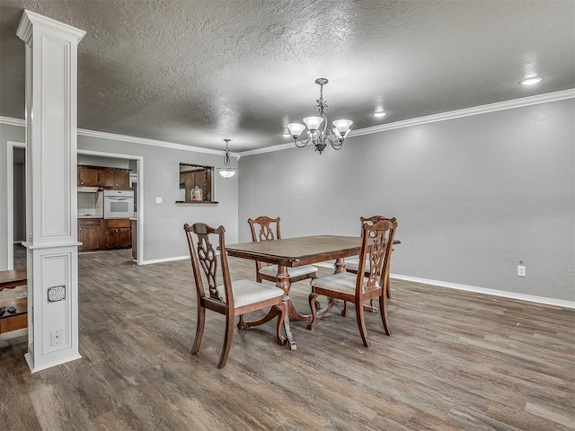 dining room with dark wood-type flooring, ornate columns, and crown molding