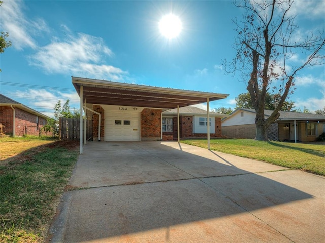 exterior space with a carport, a garage, and a front yard