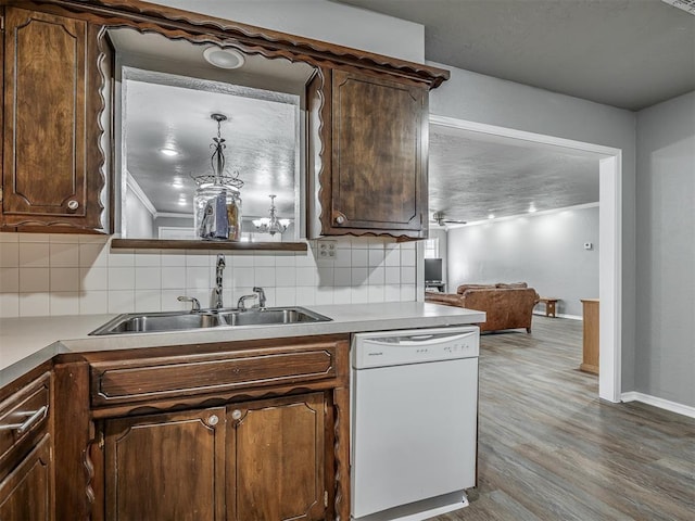 kitchen with hardwood / wood-style floors, dishwasher, sink, and tasteful backsplash