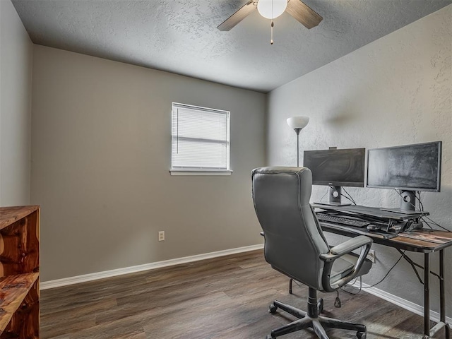 home office featuring a textured ceiling, ceiling fan, and dark hardwood / wood-style floors