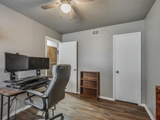 office space featuring ceiling fan, wood-type flooring, and a textured ceiling