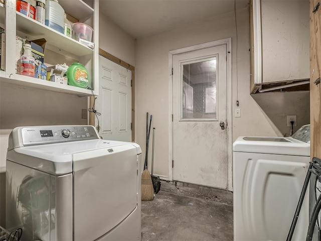 laundry room featuring cabinets and washer and dryer