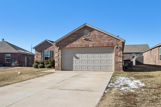 view of front of home featuring central AC unit, a garage, and a front lawn