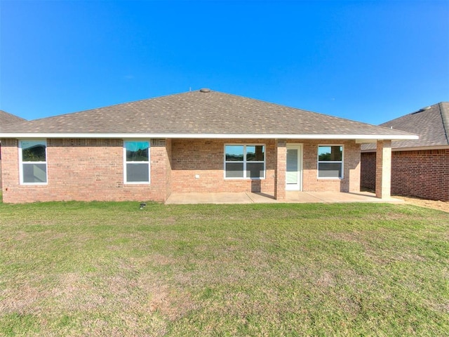 back of property featuring a patio area and a yard