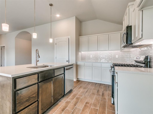 kitchen featuring white cabinets, stainless steel appliances, hanging light fixtures, and sink