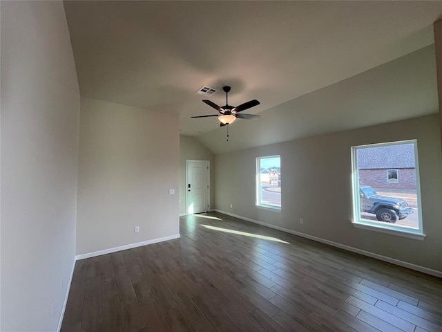 unfurnished room featuring ceiling fan, dark hardwood / wood-style flooring, and vaulted ceiling