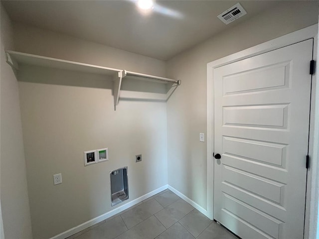 washroom featuring electric dryer hookup, hookup for a washing machine, and light tile patterned floors