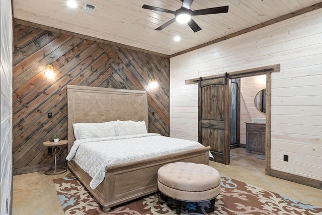 bedroom featuring ceiling fan, wooden ceiling, a barn door, and wooden walls