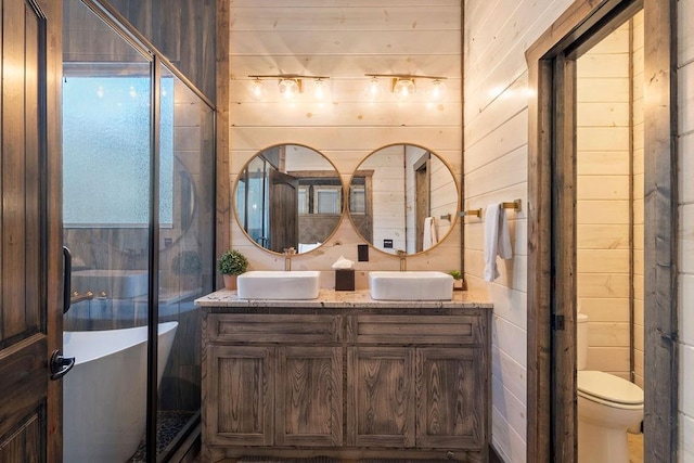 bathroom featuring toilet, vanity, a bathing tub, and wooden walls