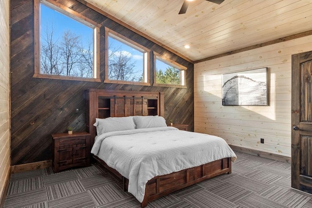 bedroom with ceiling fan, wooden walls, and wooden ceiling