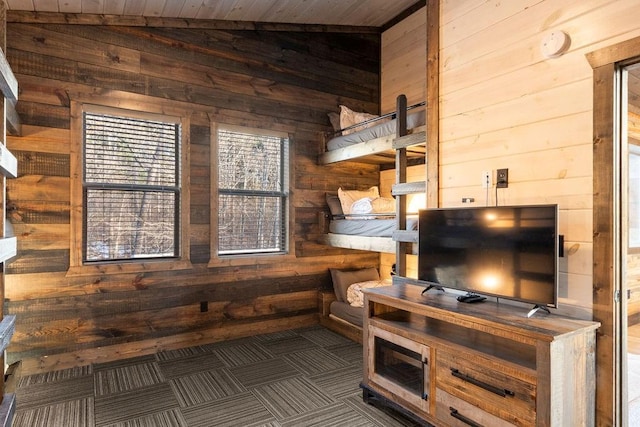 interior space featuring vaulted ceiling and wooden walls