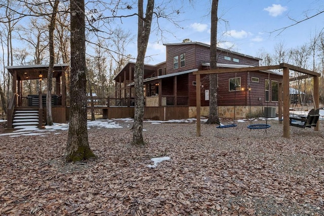 exterior space featuring central air condition unit and a sunroom