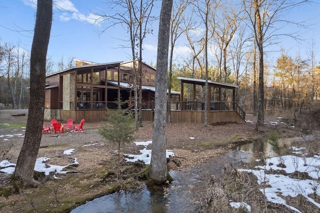 view of yard featuring a deck and a sunroom