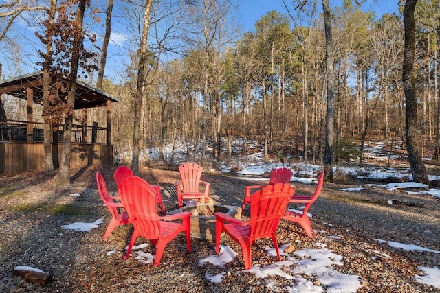 snowy yard featuring an outdoor fire pit