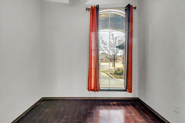 spare room featuring dark hardwood / wood-style floors