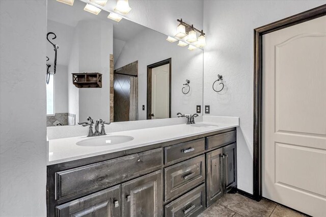 bathroom with tile patterned floors and vanity