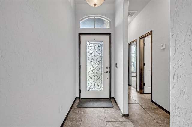 foyer entrance with light tile patterned floors