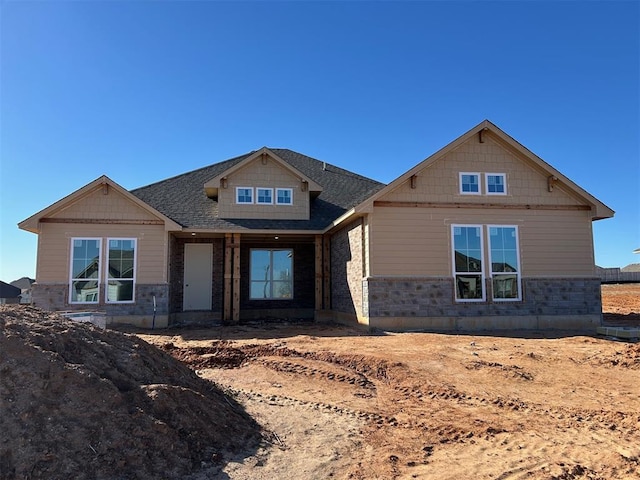 craftsman-style house with stone siding