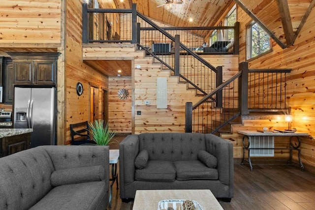 living room with high vaulted ceiling, dark hardwood / wood-style flooring, wood ceiling, and wooden walls