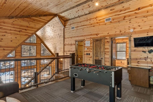 rec room featuring high vaulted ceiling, wooden ceiling, dark carpet, and wood walls