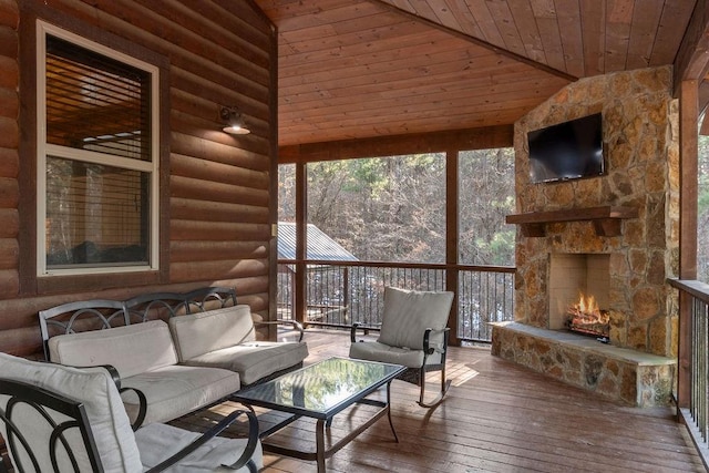 sunroom featuring lofted ceiling, an outdoor stone fireplace, and wooden ceiling