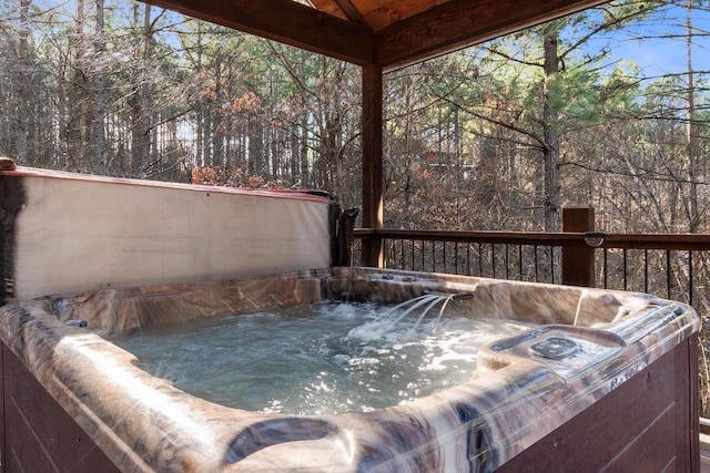 wooden deck featuring a hot tub