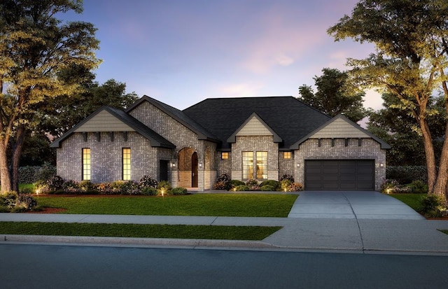 view of front of house with a yard and a garage