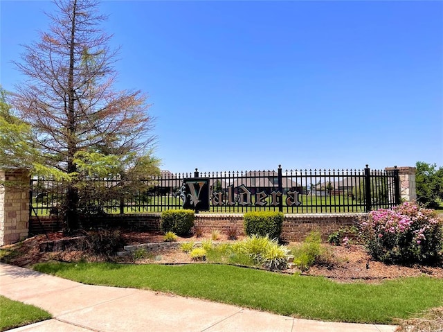 view of home's community featuring fence