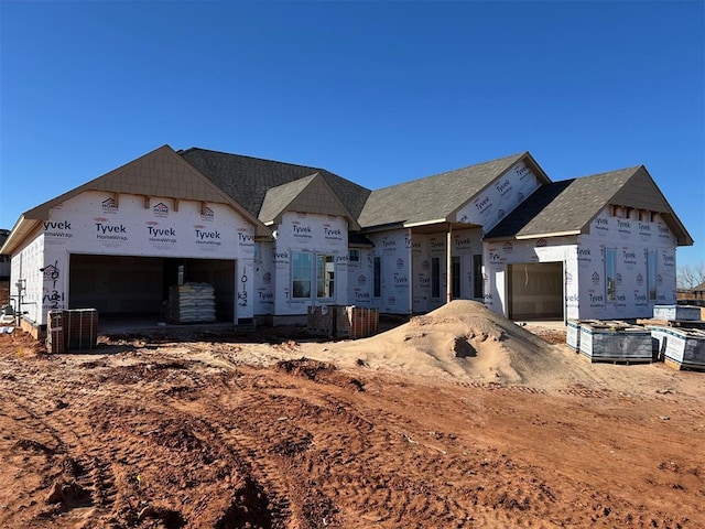 property under construction featuring an attached garage and cooling unit