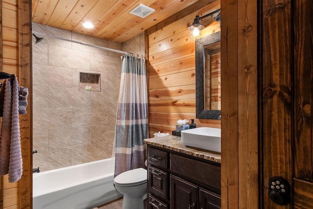 full bathroom featuring toilet, vanity, wood walls, shower / bath combo with shower curtain, and wooden ceiling