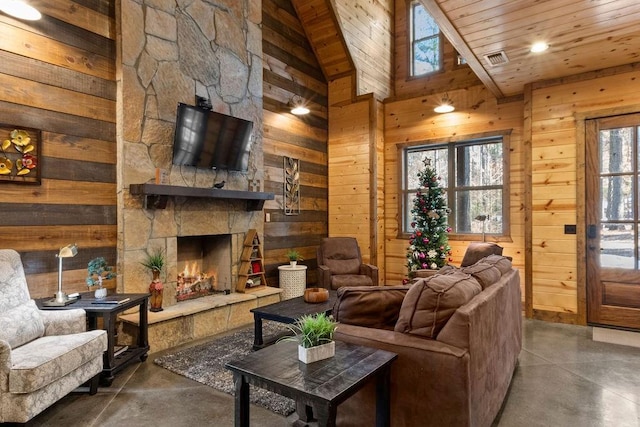 living room featuring wood ceiling, a stone fireplace, wood walls, high vaulted ceiling, and concrete flooring