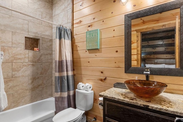 full bathroom featuring toilet, shower / tub combo, wood walls, and vanity