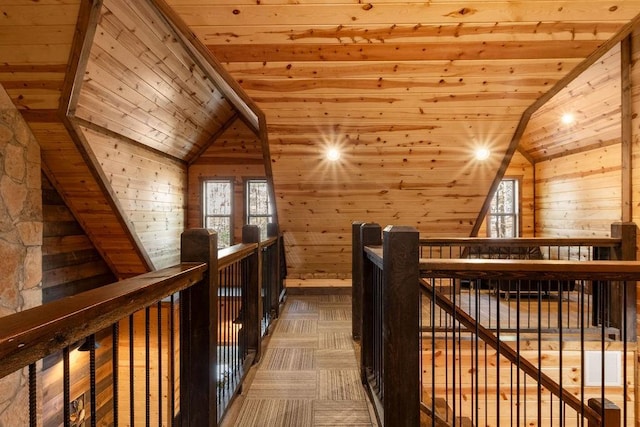 interior space featuring vaulted ceiling, wood ceiling, and wooden walls