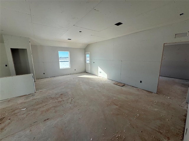 empty room featuring lofted ceiling