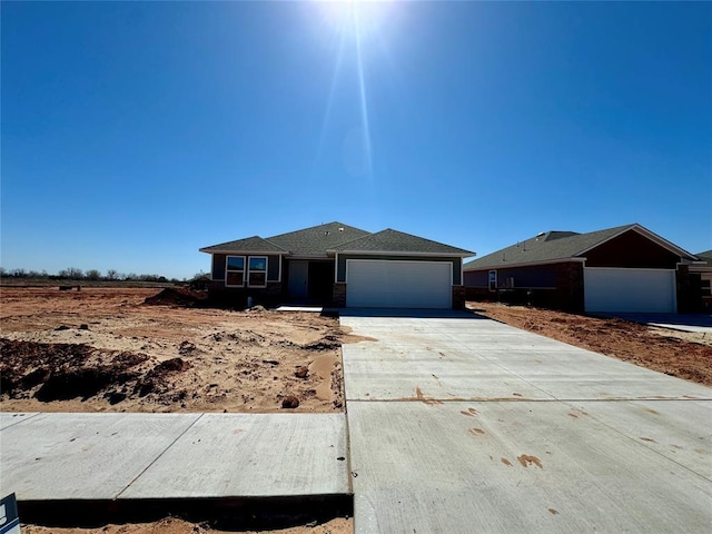 view of front of home featuring concrete driveway and an attached garage