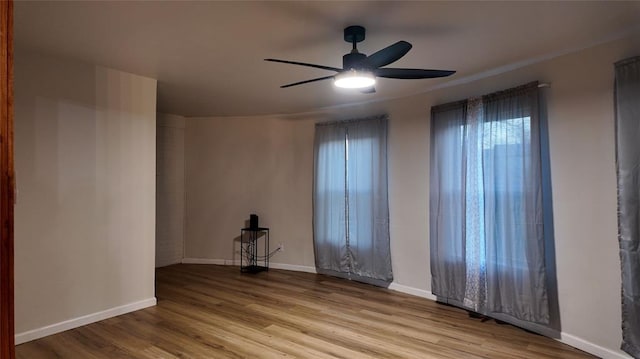 unfurnished room featuring ceiling fan and light wood-type flooring