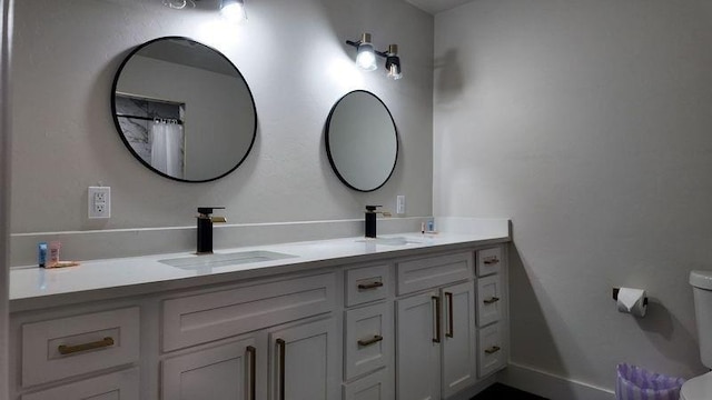 bathroom featuring toilet and vanity