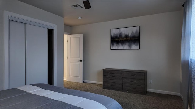 carpeted bedroom featuring ceiling fan and a closet