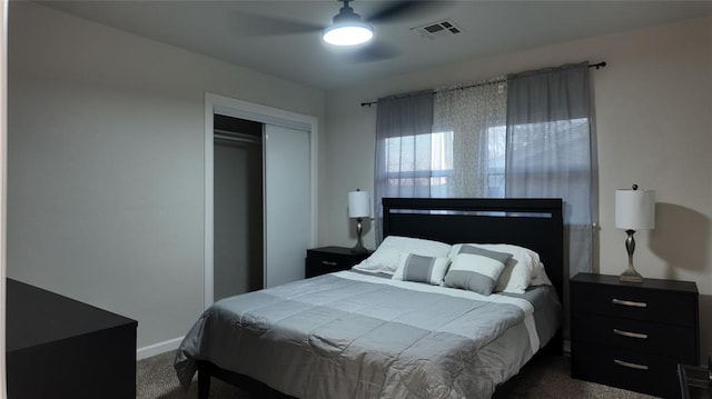 bedroom featuring ceiling fan, a closet, and dark carpet