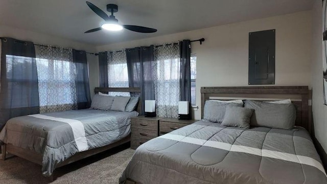 carpeted bedroom with ceiling fan and electric panel