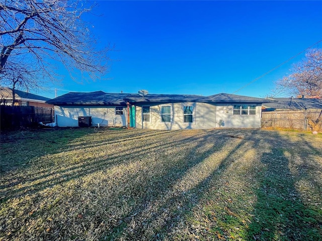 rear view of house featuring a yard