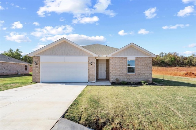 view of front of property with a front yard and a garage