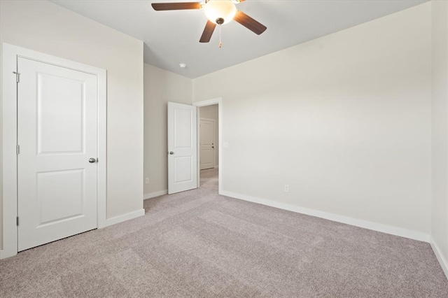 unfurnished bedroom with light colored carpet and ceiling fan