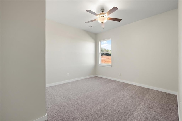 carpeted spare room with ceiling fan