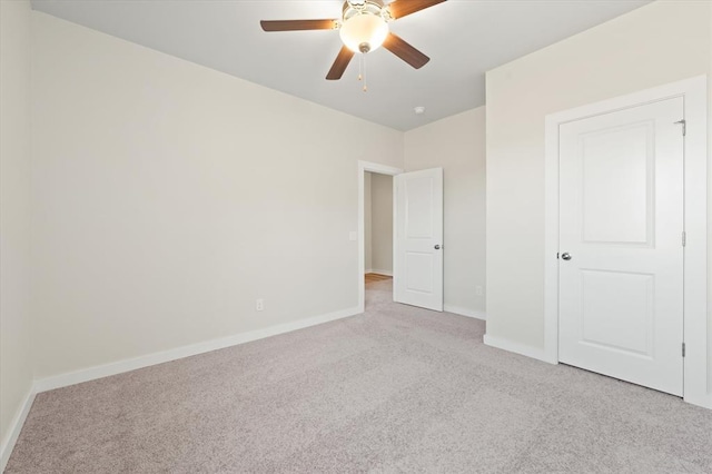 unfurnished bedroom featuring light carpet and ceiling fan