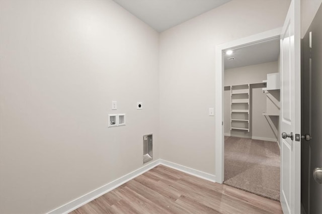 washroom with washer hookup, light hardwood / wood-style floors, and electric dryer hookup