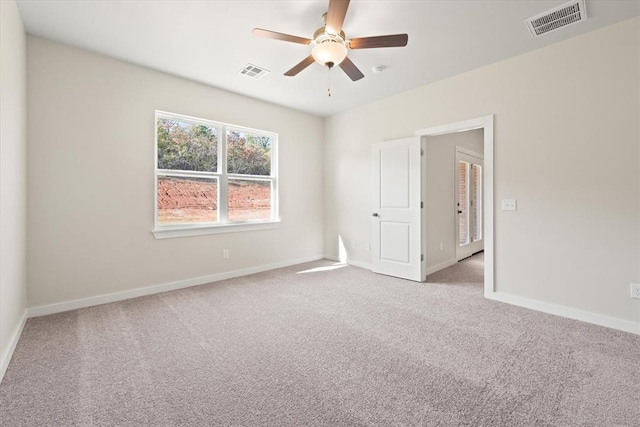 carpeted spare room with ceiling fan