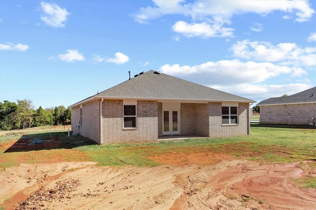 rear view of house featuring french doors